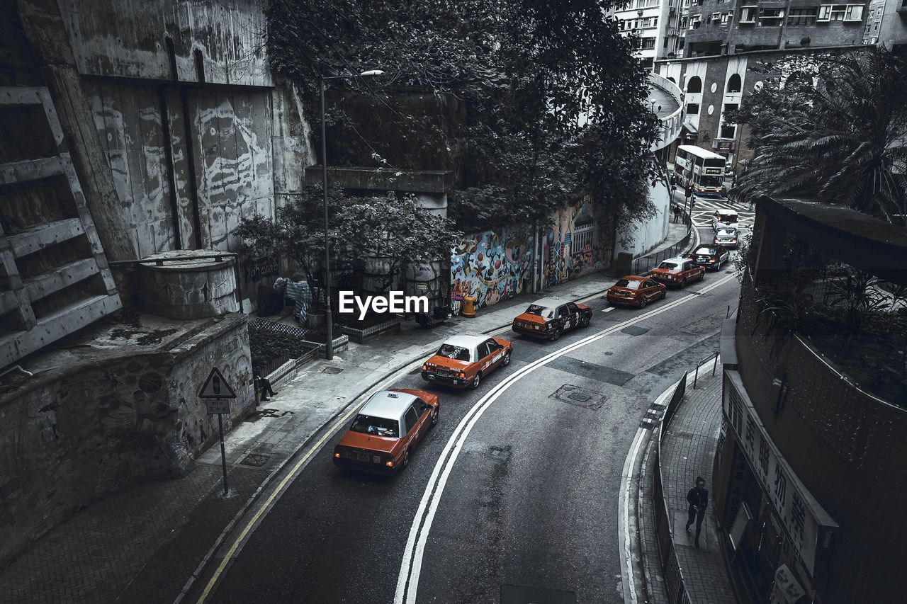 CARS ON ROAD ALONG BUILDINGS