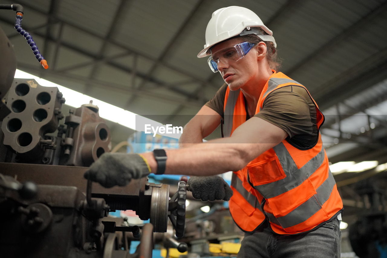 Portrait of male worker standing in the heavy industry manufacturing factory.