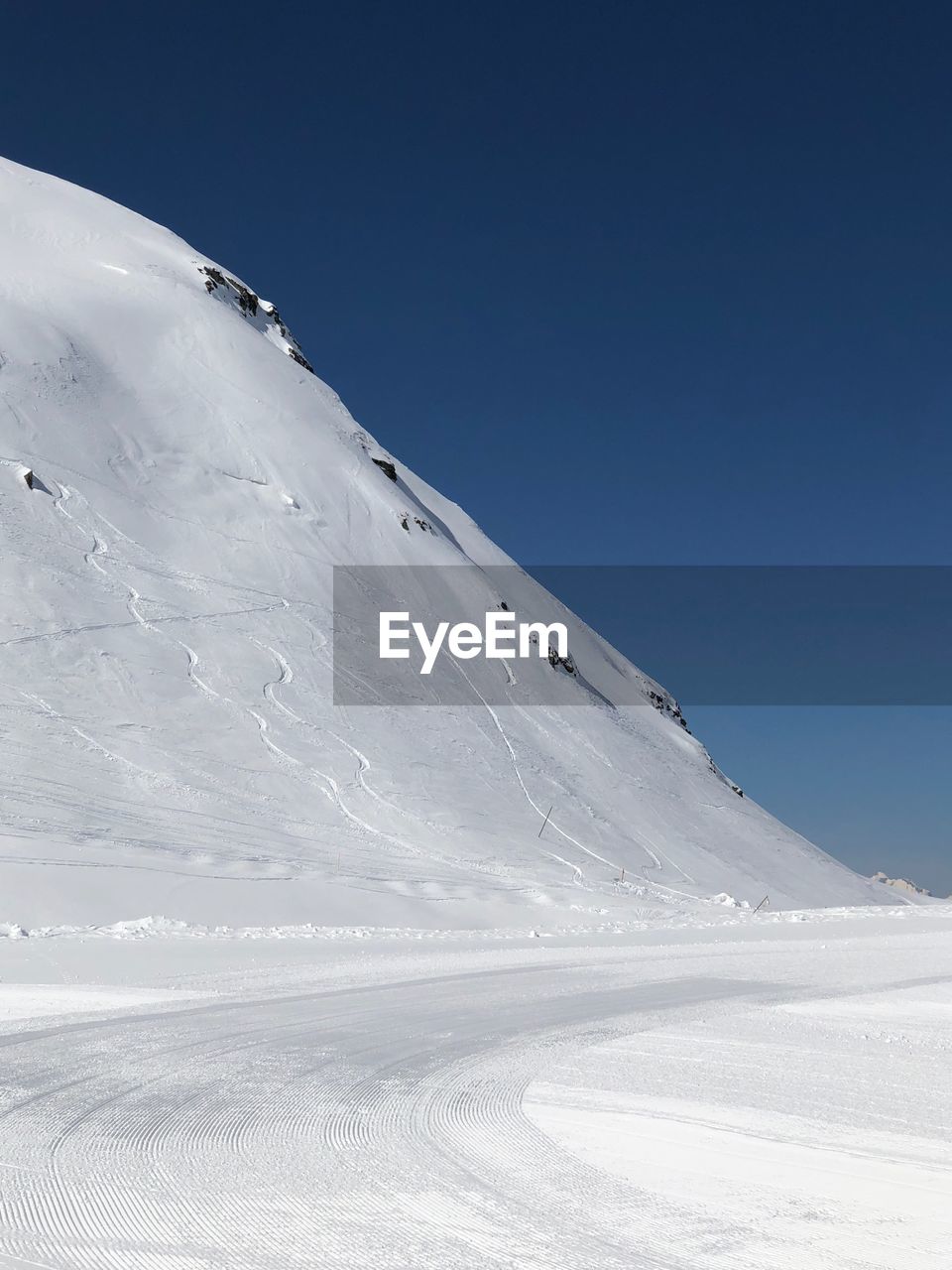 Scenic view of snowcapped mountain against clear sky