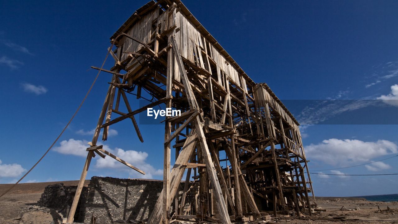 Low angle view of built structure against blue sky