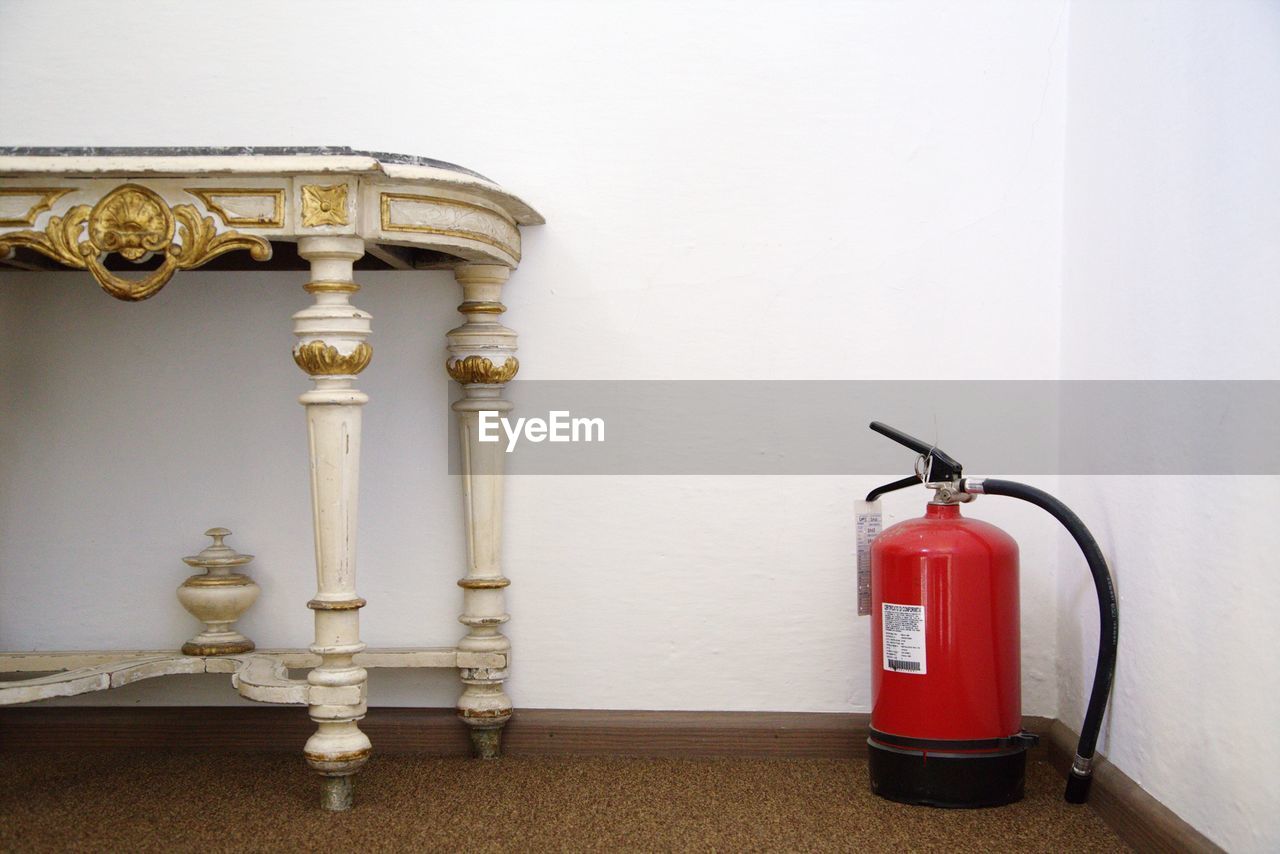 Fire extinguisher beside wooden table