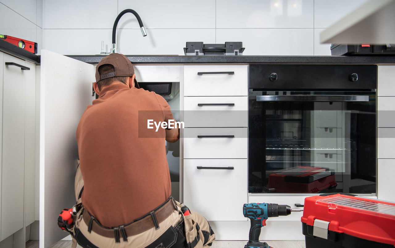 Rear view of man working at home