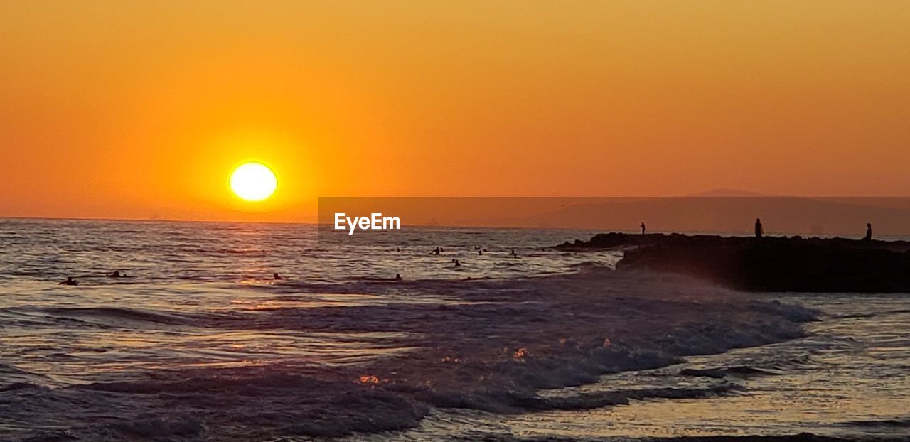 SCENIC VIEW OF BEACH DURING SUNSET