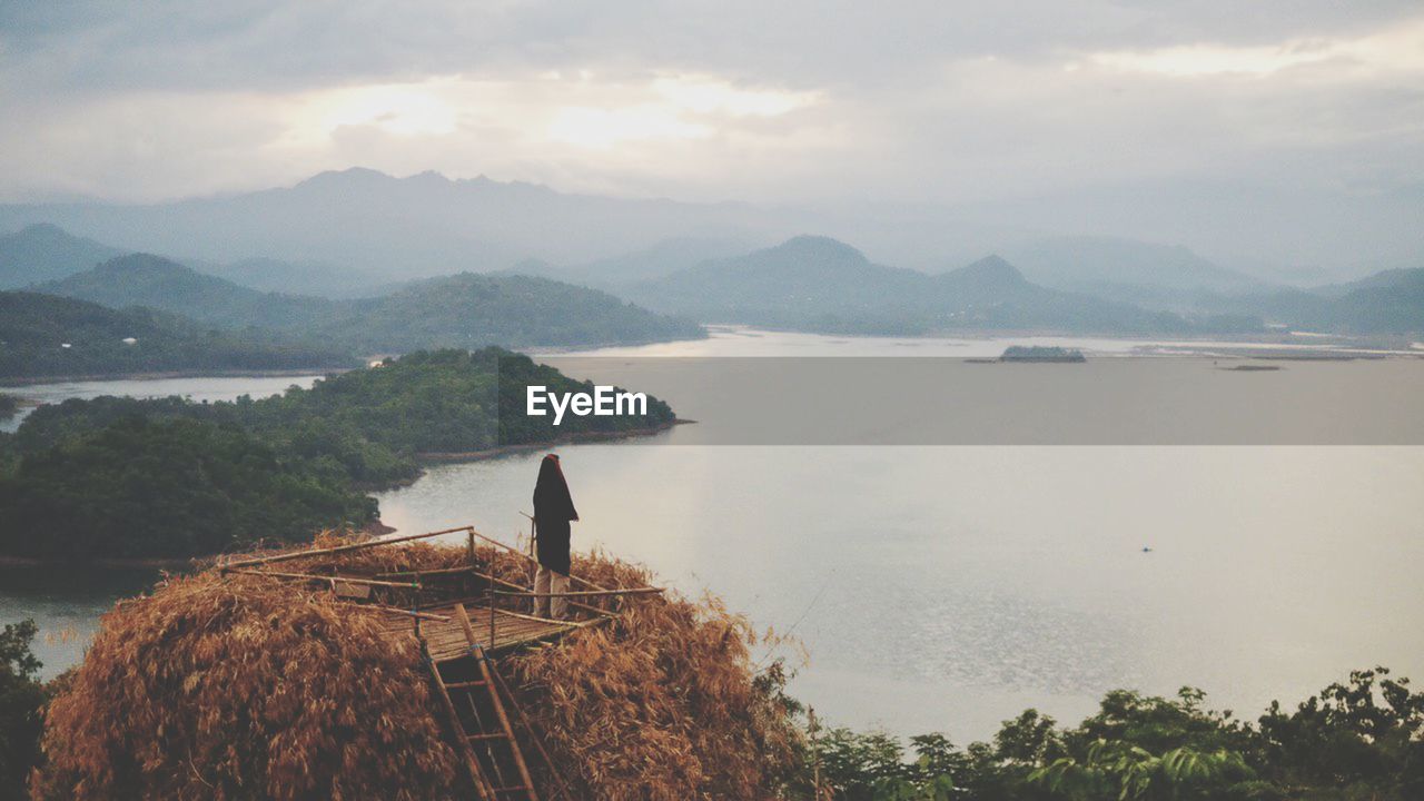 High angle view of sea and mountains against sky