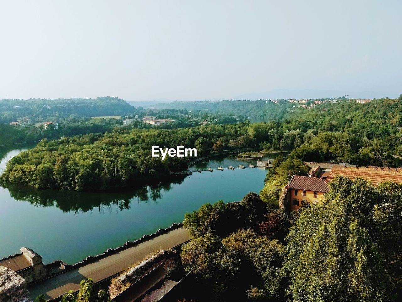 High angle view of river by trees against sky