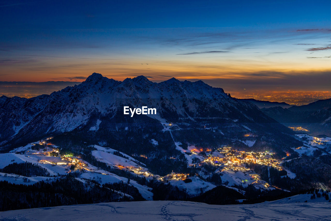 Snowy mountain village at sunset