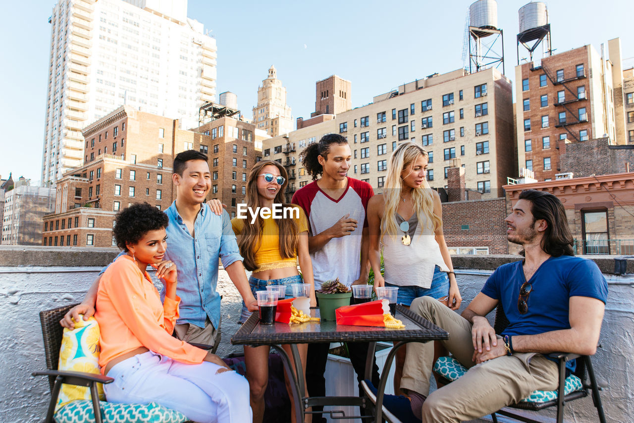 GROUP OF PEOPLE SITTING AT RESTAURANT