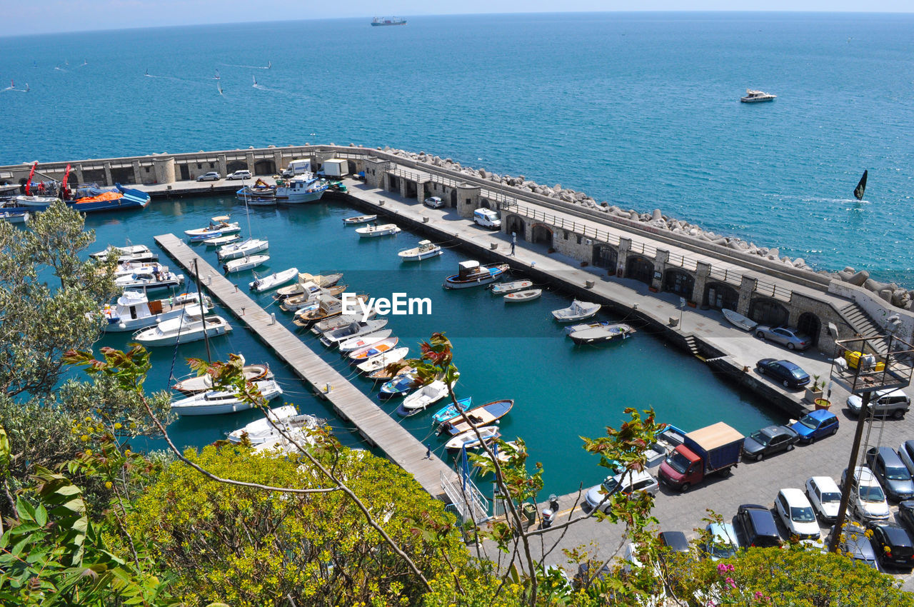 High angle view of harbor by sea against sky