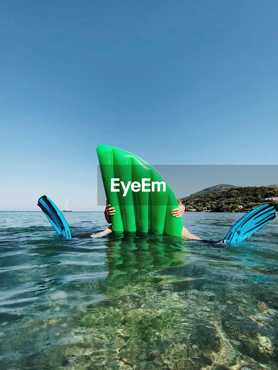 Multi colored umbrella on swimming pool against sea