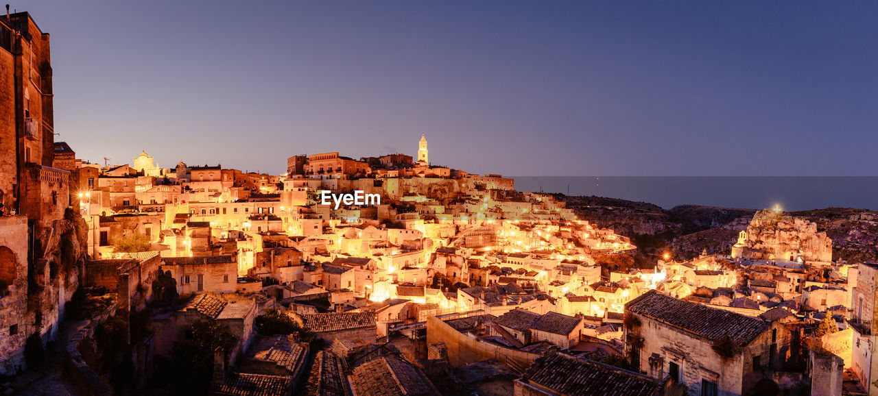 Panorama of matera from piazzetta pascoli at night with illuminated houses