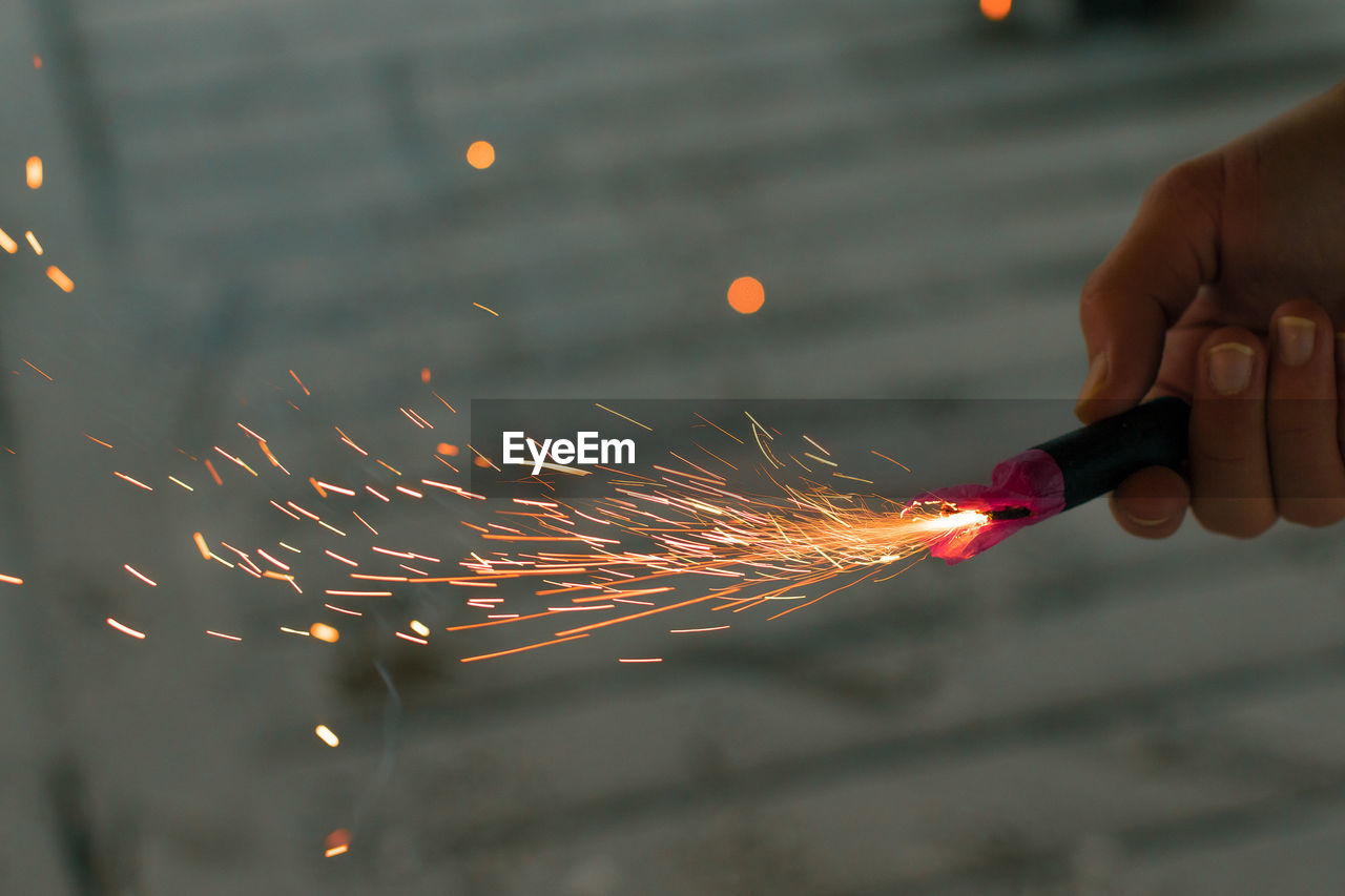 hand, fireworks, one person, motion, holding, close-up, blurred motion, sparks, light, macro photography, finger, sparkler, adult, focus on foreground, burning, red, nature, occupation