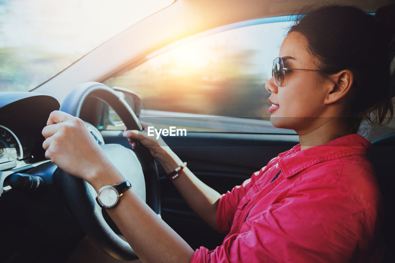 Young woman sitting in car