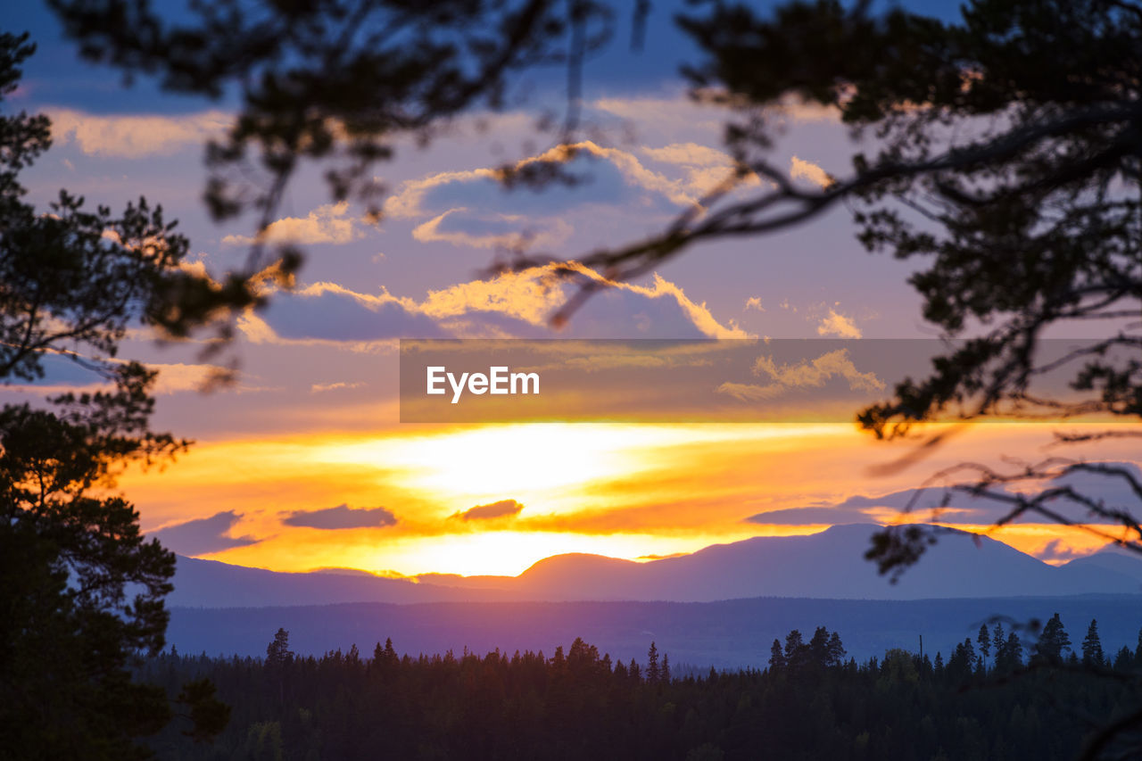 Scenic view of silhouette mountains against sky at sunset