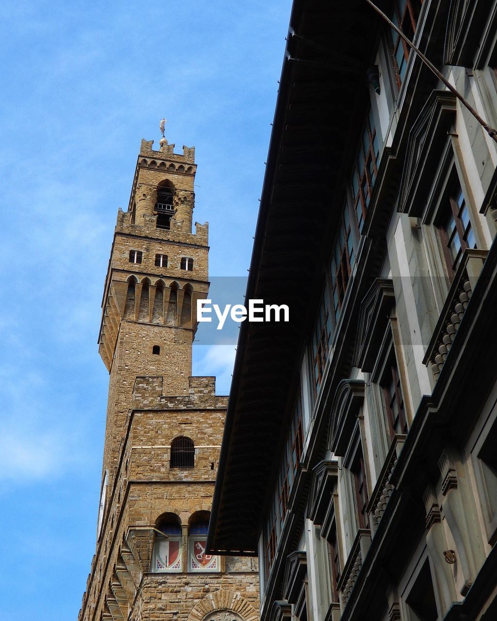 LOW ANGLE VIEW OF BUILDINGS IN CITY AGAINST SKY