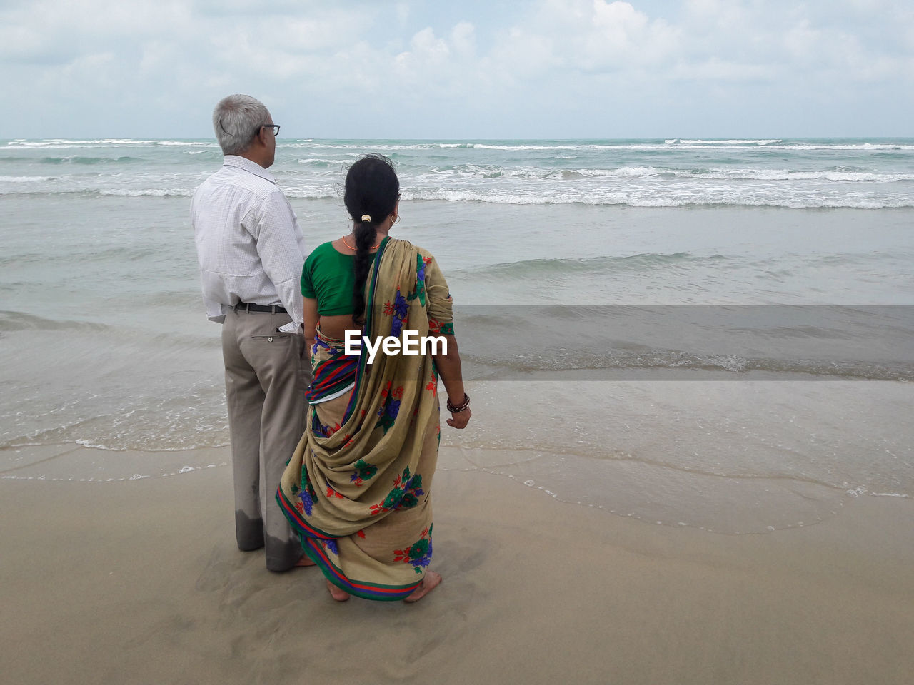 Rear view of man standing on beach