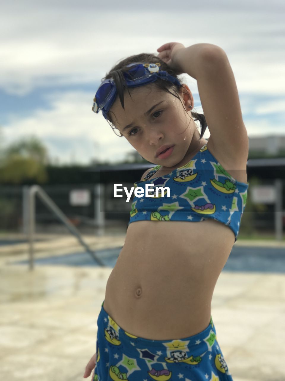Cute girl wearing swimwear on poolside