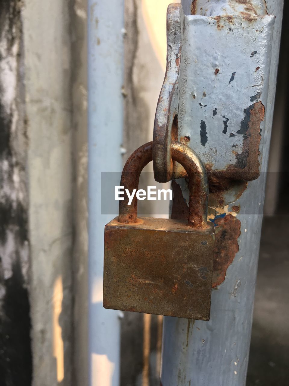 Close-up of padlock on rusty metal