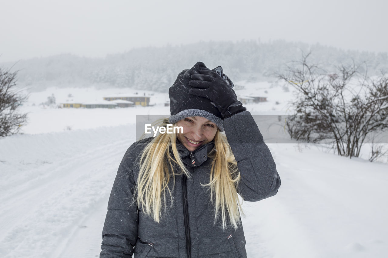 Portrait of smiling young woman during winter