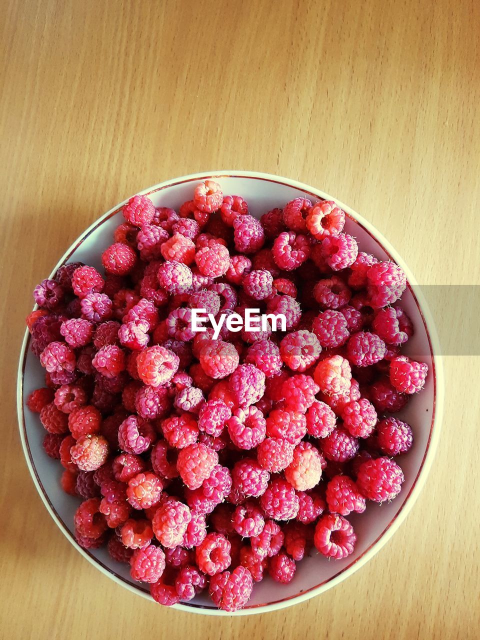 High angle view of rasberries in bowl on table