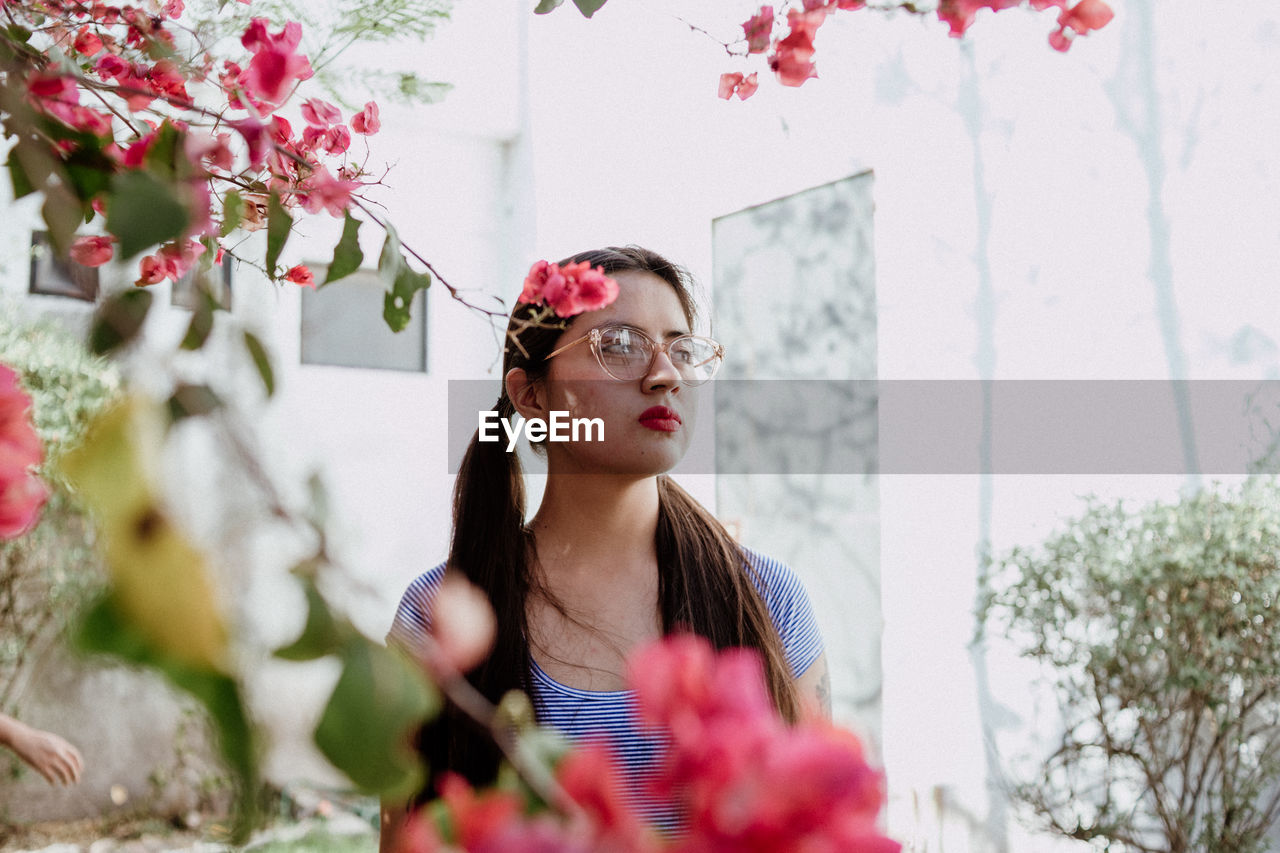 Young woman wearing sunglasses standing outdoors