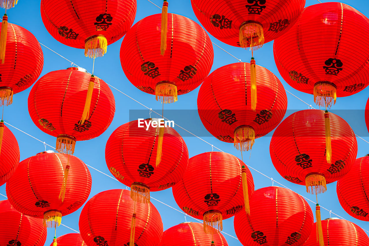 Low angle view of illuminated lanterns hanging at night