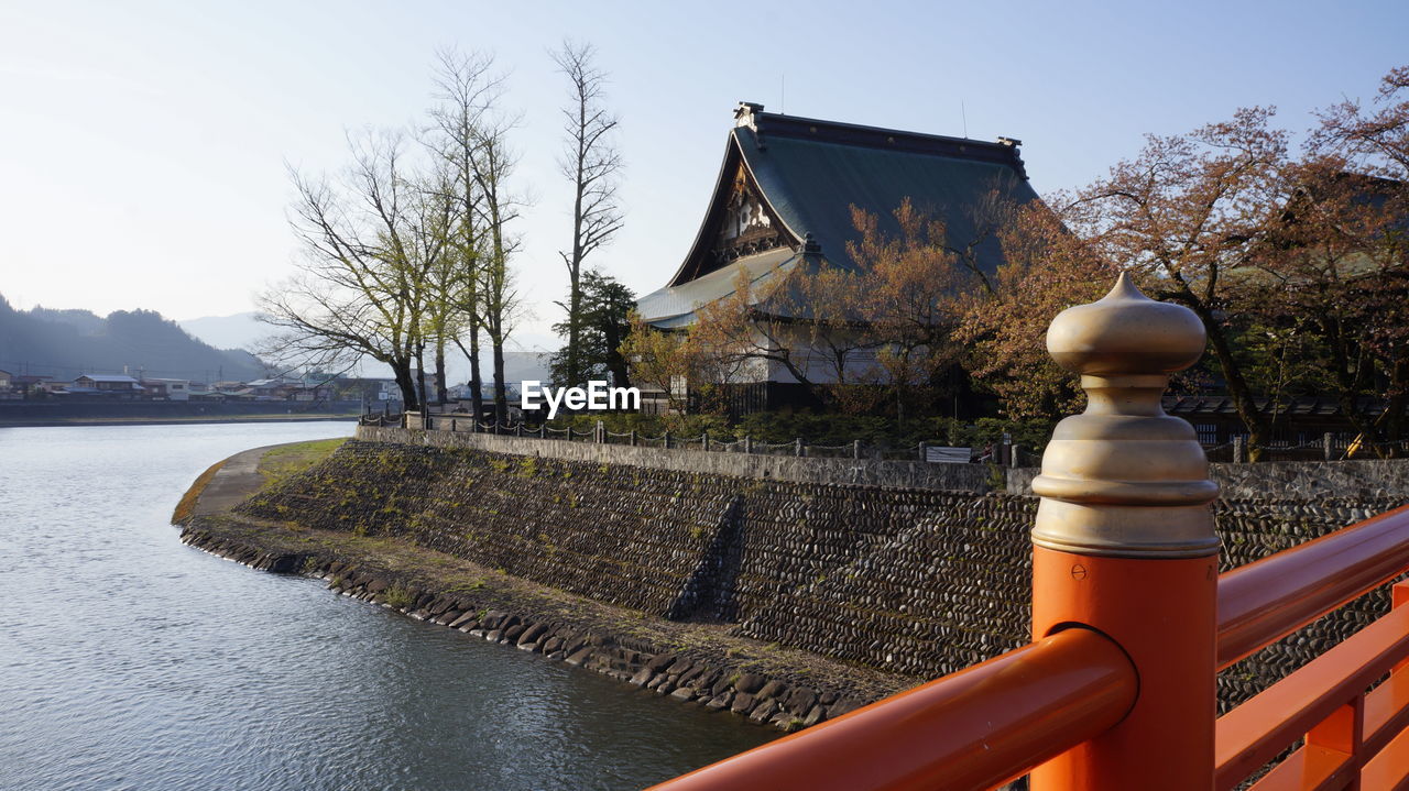 HOUSE BY RIVER AGAINST SKY