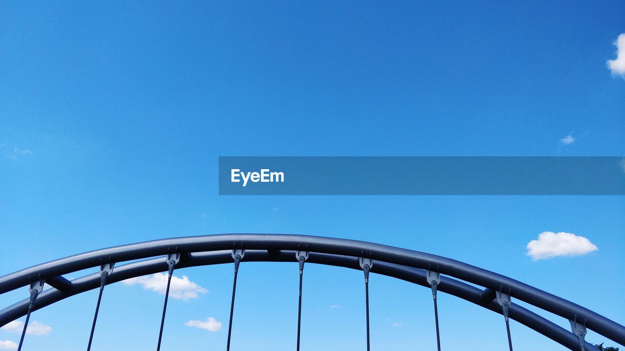 Low angle view of bridge against blue sky