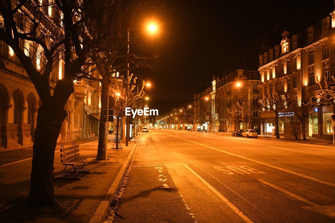 Illuminated city street at night