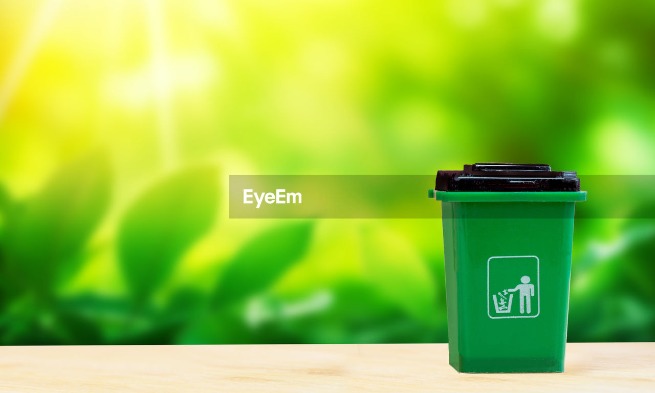 green, environmental conservation, yellow, environment, no people, waste container, nature, focus on foreground, recycling, environmental issues, communication, lighting, copy space, indoors, wood, container