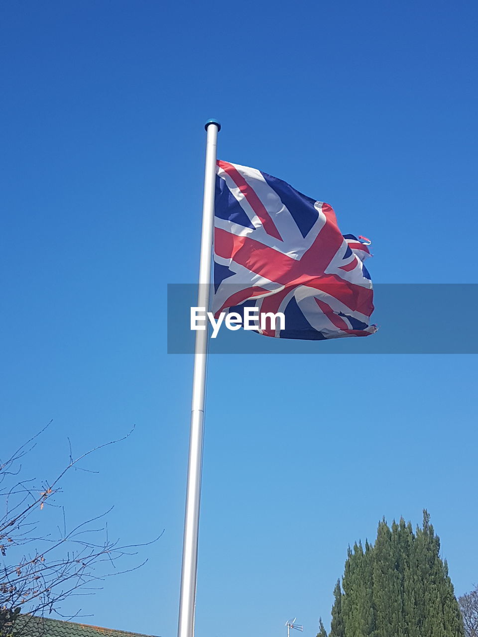 LOW ANGLE VIEW OF FLAG FLAGS AGAINST CLEAR BLUE SKY