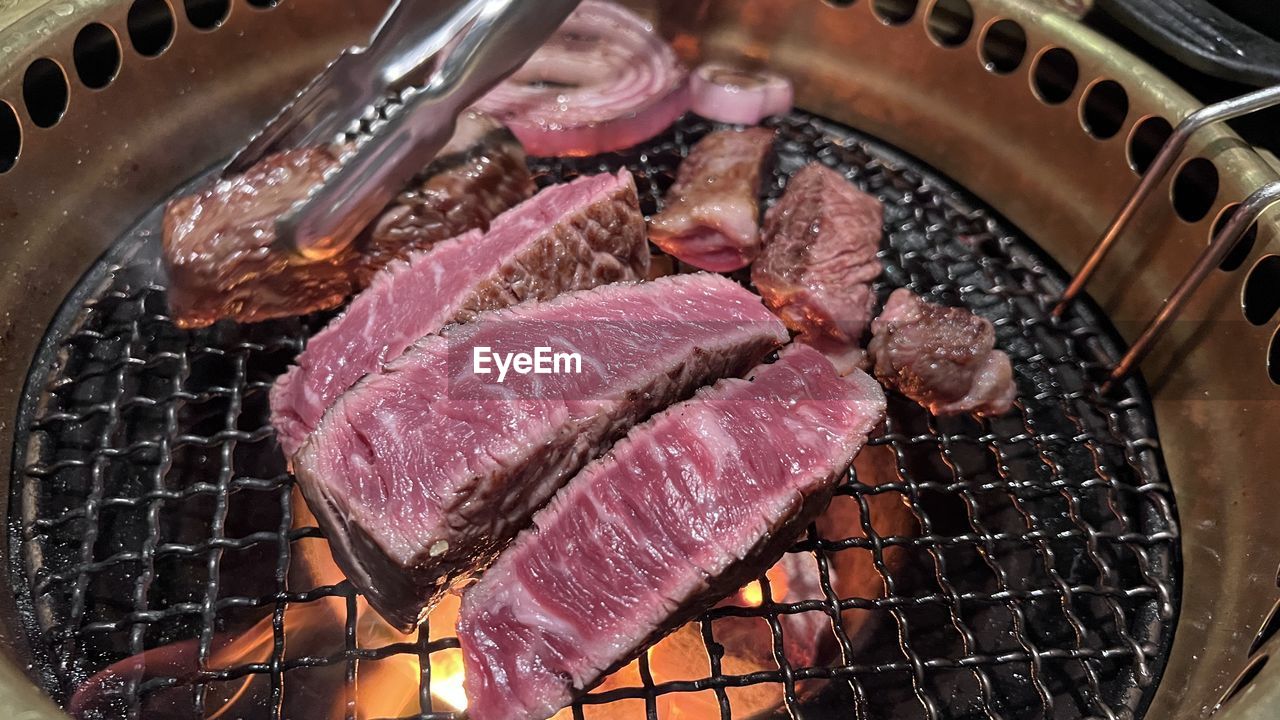 food, meat, food and drink, yakiniku, freshness, barbecue, red meat, barbecue grill, dish, horumonyaki, cooking, grilled, beef, heat, roasting, kobe beef, high angle view, no people, grilling, preparing food, steak, metal, kitchen utensil, close-up, cuisine, samgyeopsal, indoors, venison, raw food, still life