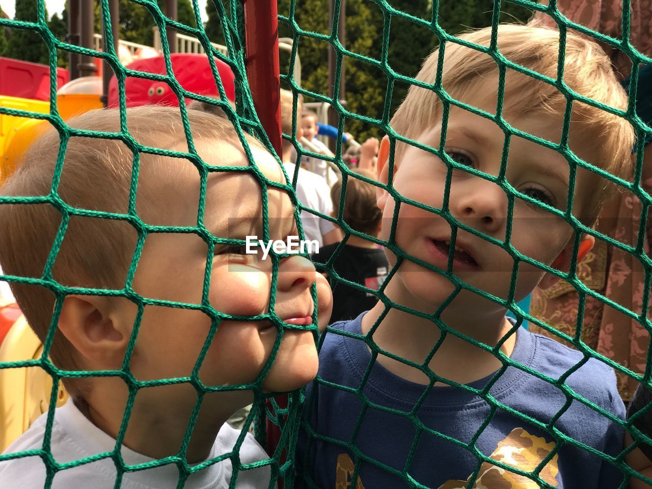 CLOSE-UP OF BOY ON PLAYGROUND