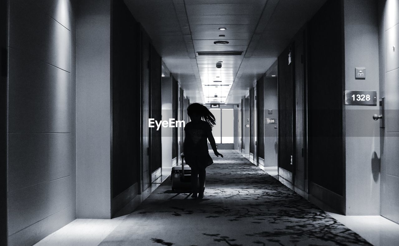 WOMAN STANDING ON CORRIDOR