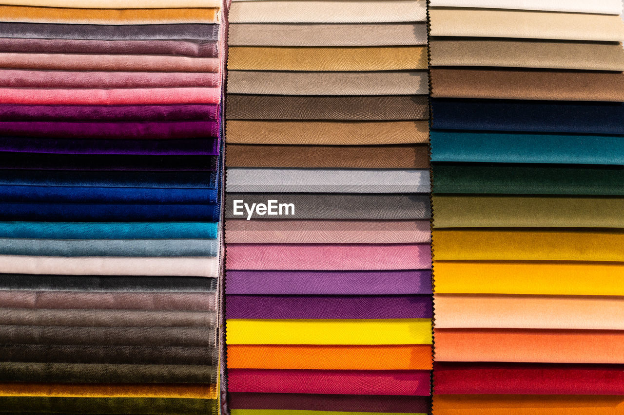 Catalog of multi-colored fabric samples. textile industry background. colored cotton fabric. palet