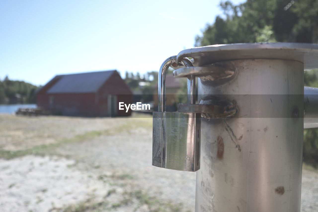 CLOSE-UP OF METALLIC STRUCTURE ON FIELD AGAINST SKY