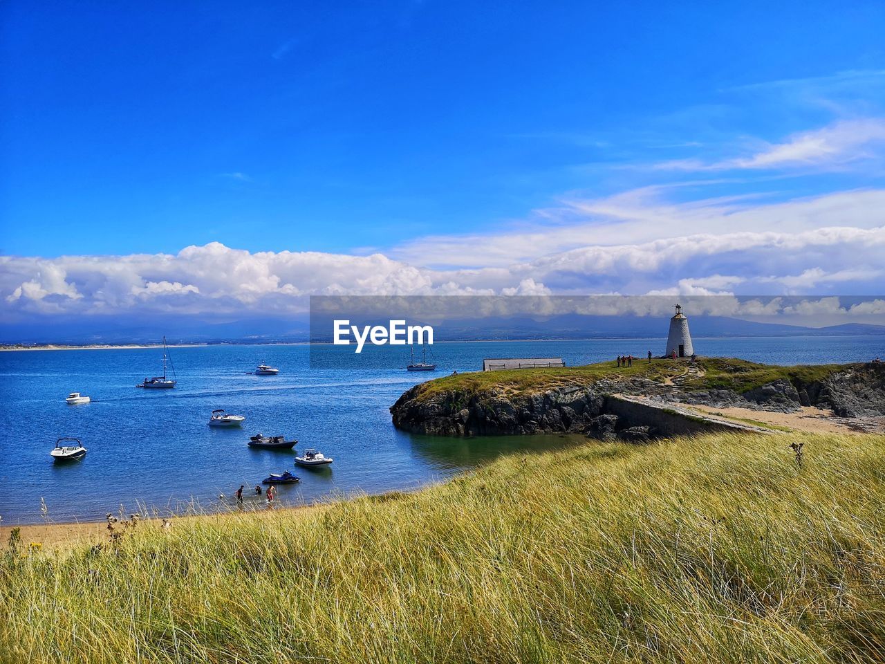 water, sky, sea, shore, horizon, coast, land, nature, scenics - nature, beach, lighthouse, ocean, cloud, beauty in nature, architecture, nautical vessel, body of water, blue, travel, grass, travel destinations, landscape, environment, built structure, plant, coastline, no people, bay, transportation, tranquility, building, tower, building exterior, guidance, tranquil scene, tourism, outdoors, day, cove, cliff, holiday, vacation, trip, non-urban scene, reflection, summer, island, horizon over water, idyllic, terrain, mode of transportation