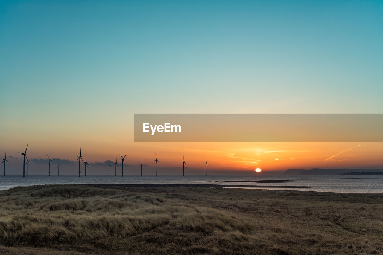 SCENIC VIEW OF LAND AGAINST SKY DURING SUNSET