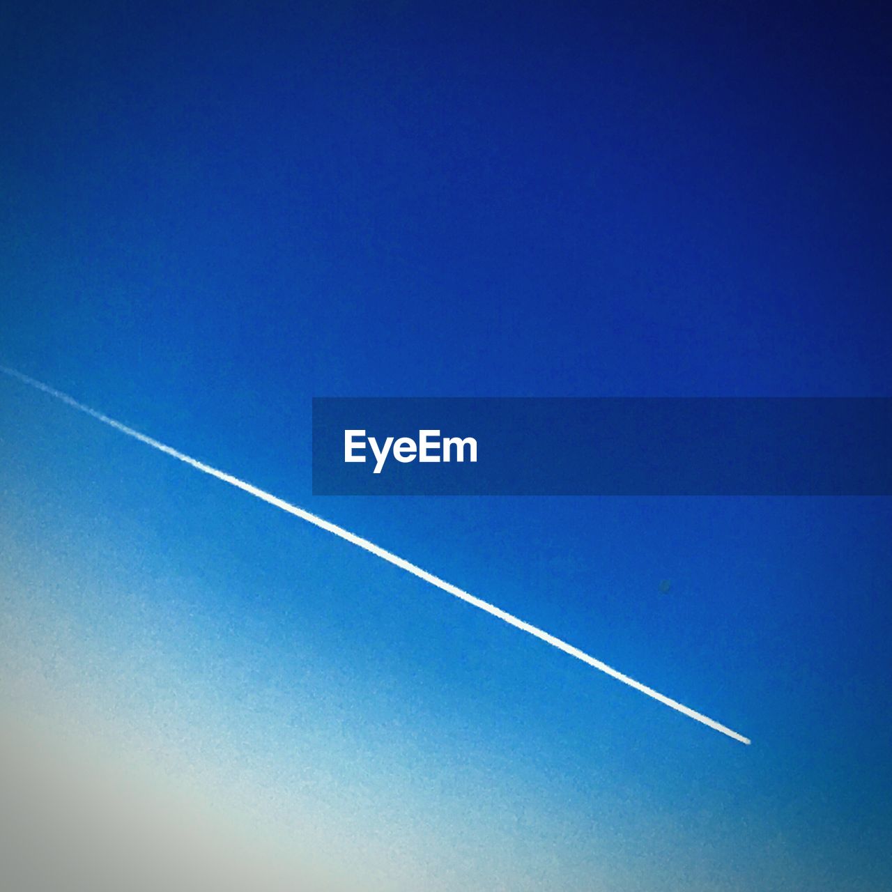 LOW ANGLE VIEW OF VAPOR TRAIL IN SKY