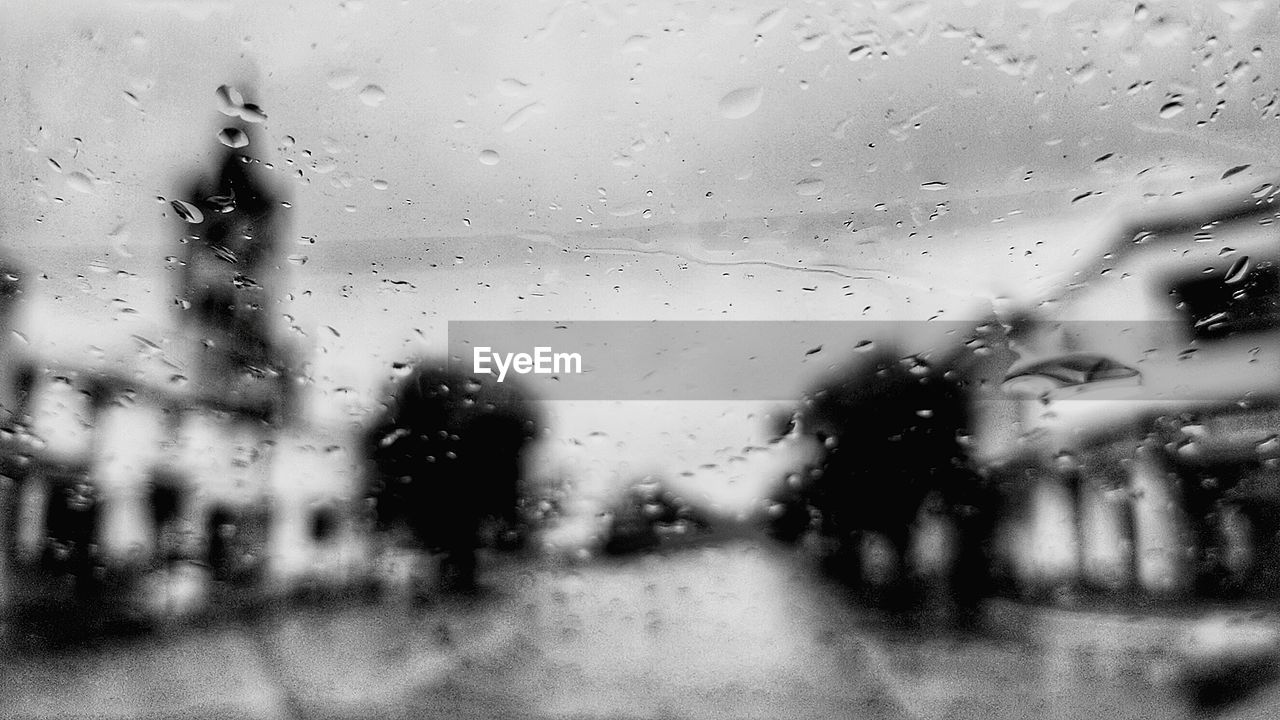 CLOSE-UP OF WATER AGAINST SKY SEEN FROM GLASS