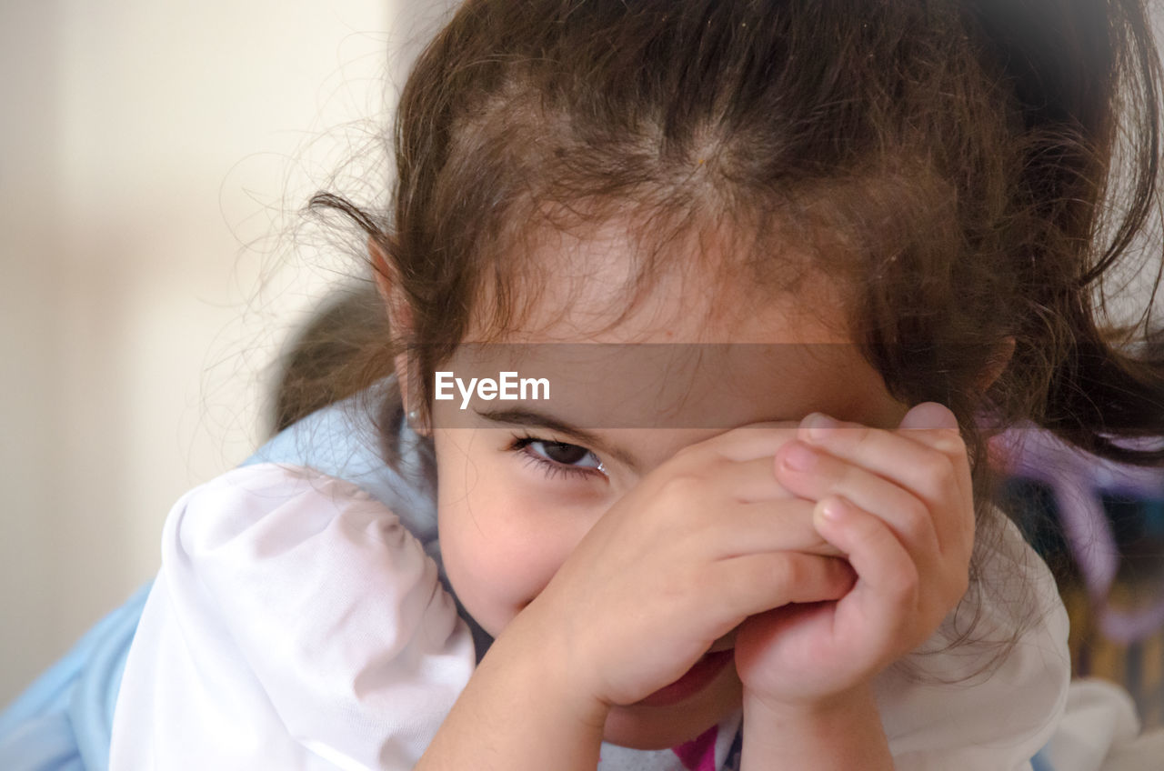 Close-up portrait of cute girl at home