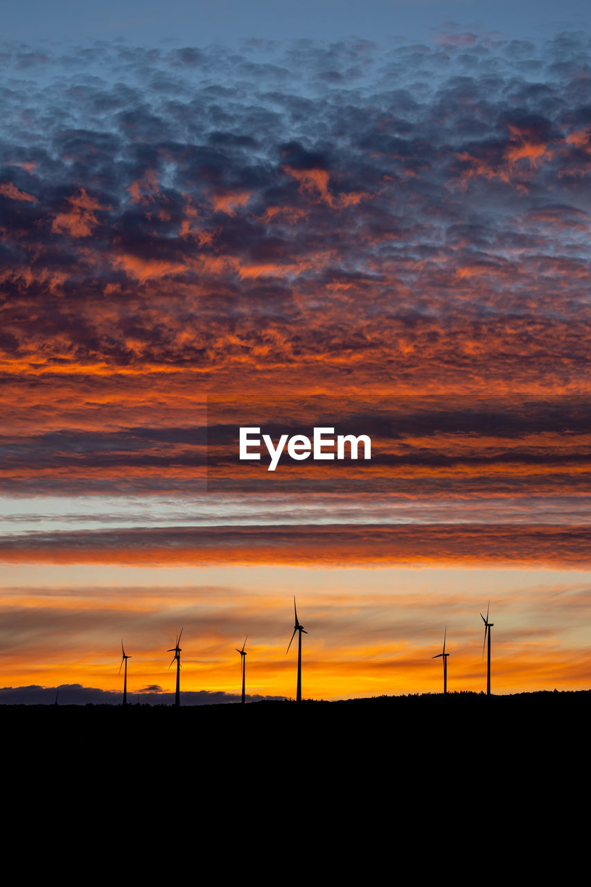 SCENIC VIEW OF SILHOUETTE FIELD AGAINST ORANGE SKY