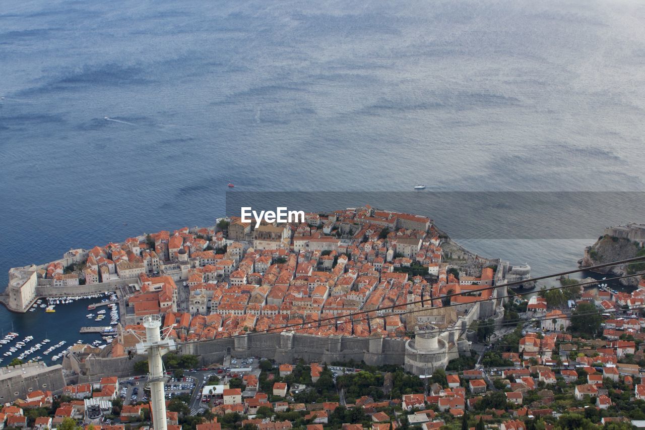 High angle view of townscape by sea