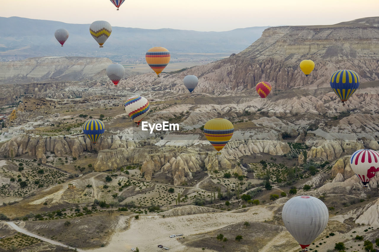 View of hot air balloons flying over rocks