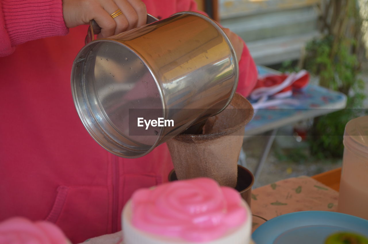 HIGH ANGLE VIEW OF HAND HOLDING ICE CREAM CONE