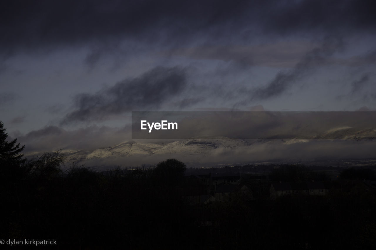 STORM CLOUDS OVER LANDSCAPE AGAINST SKY