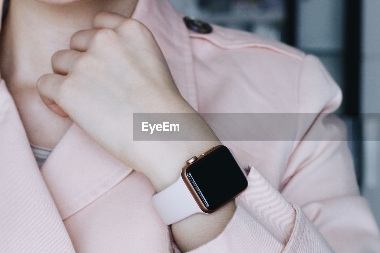 Midsection of businesswoman wearing smart watch