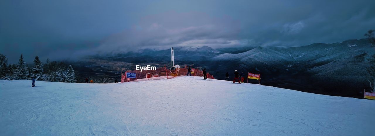 snow, cold temperature, winter, mountain, environment, landscape, scenics - nature, mountain range, sky, beauty in nature, nature, skiing, travel, travel destinations, piste, cloud, land, snowcapped mountain, architecture, tourism, vacation, tree, winter sports, ski equipment, panoramic, non-urban scene, holiday, ski, outdoors, trip, mountain peak, forest, tranquility, night, plant, frozen, adventure, built structure, sports, tranquil scene, building, pinaceae, storm
