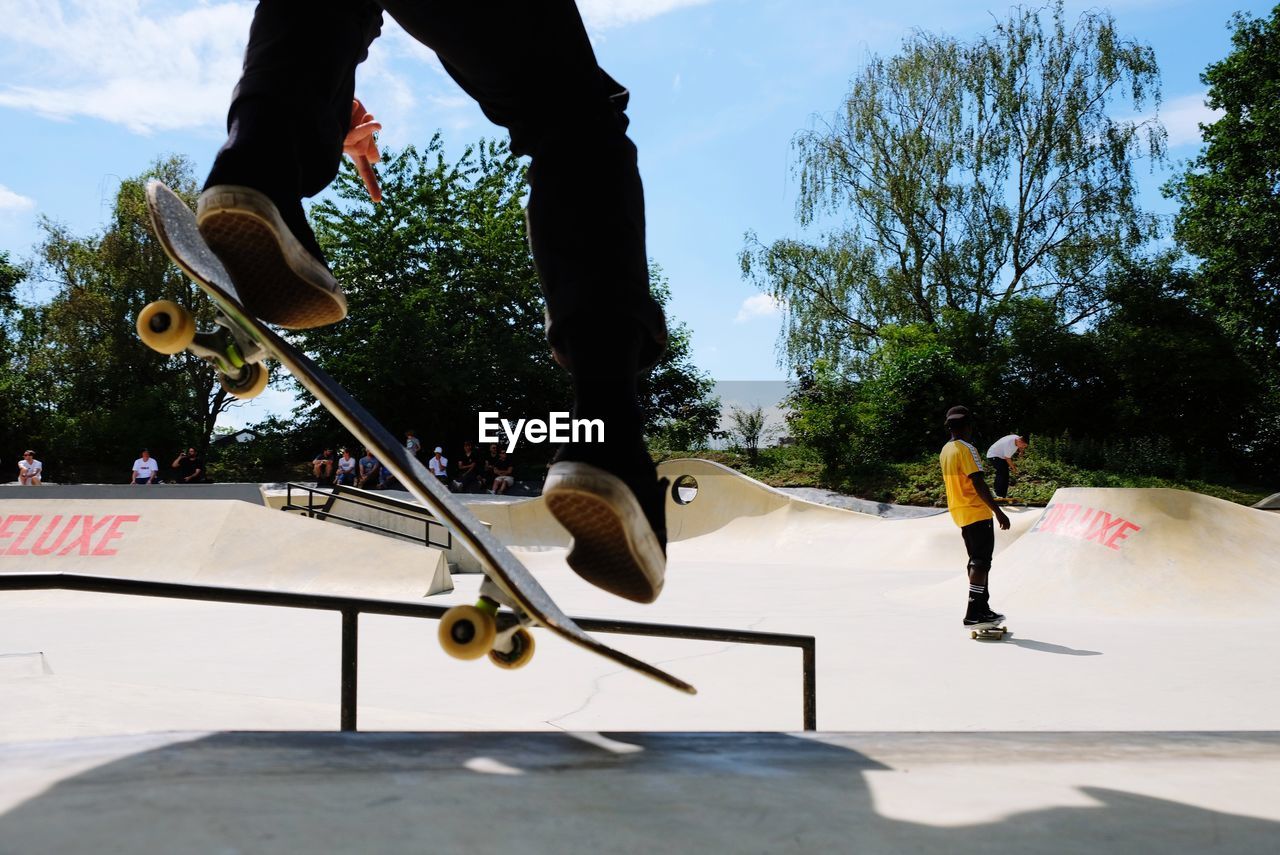 Low section of man skateboarding on sports ramp