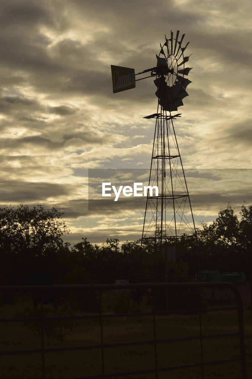 SILHOUETTE OF WINDMILL AGAINST SKY DURING SUNSET