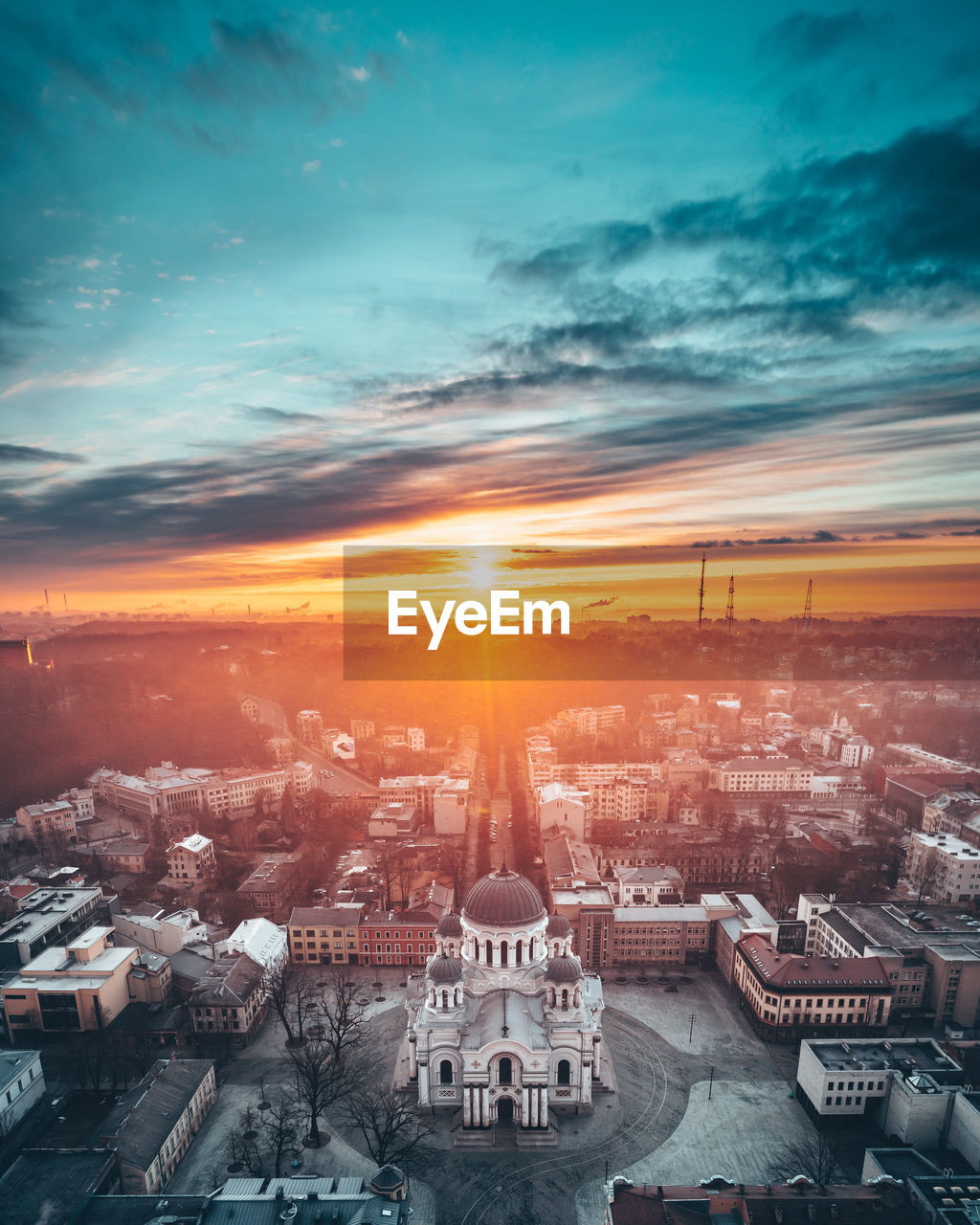 HIGH ANGLE VIEW OF CITY AGAINST SKY DURING SUNSET